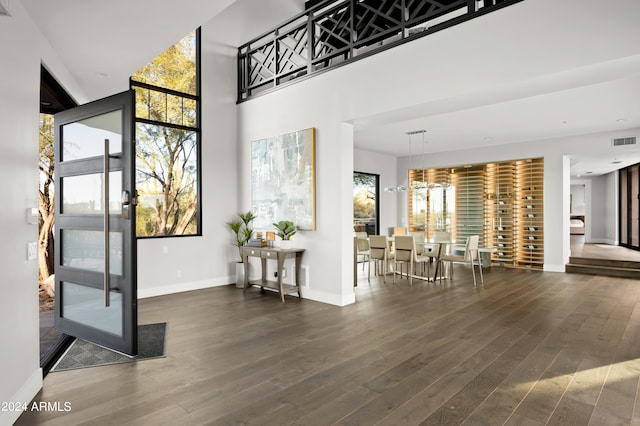 interior space featuring dark hardwood / wood-style floors and a notable chandelier