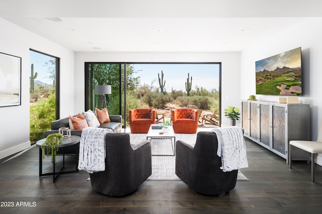 living room with plenty of natural light and dark wood-type flooring