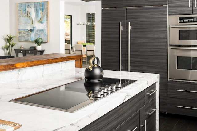 kitchen with dark hardwood / wood-style flooring and stainless steel appliances