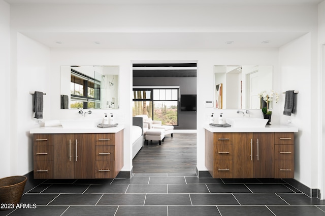 bathroom featuring double sink, oversized vanity, and wood-type flooring