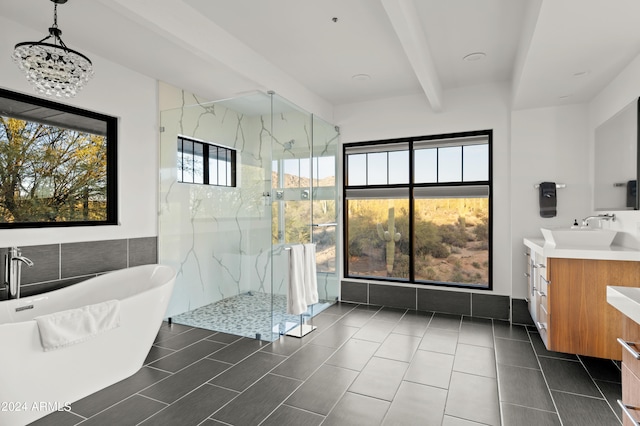 bathroom featuring tile flooring, a healthy amount of sunlight, vanity with extensive cabinet space, and beamed ceiling