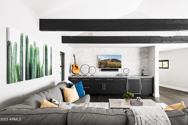 living room with dark hardwood / wood-style floors, vaulted ceiling with beams, and sink