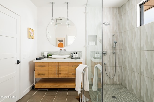 bathroom with tile flooring, walk in shower, and vanity