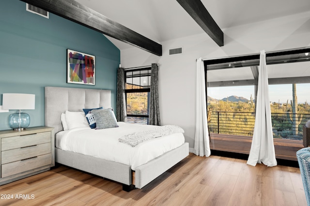 bedroom featuring vaulted ceiling with beams and light hardwood / wood-style flooring