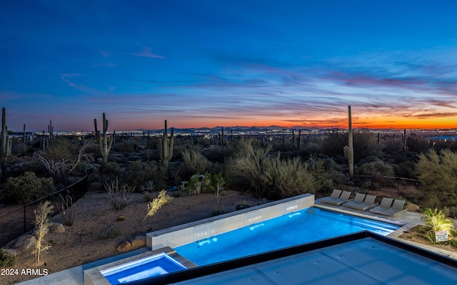 view of pool at dusk