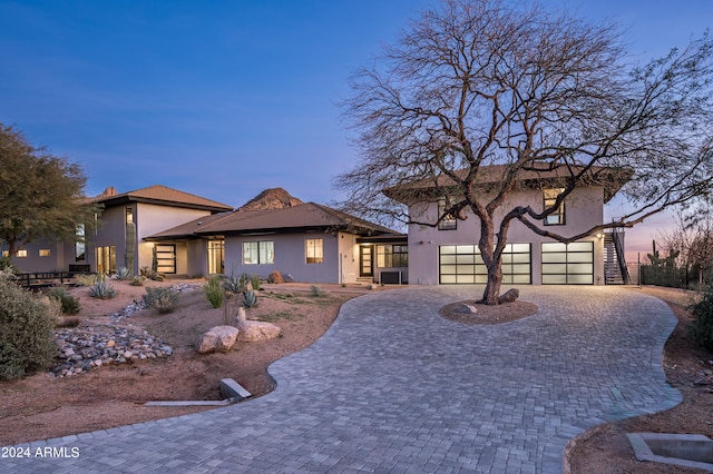 view of front of house featuring a patio area and a garage