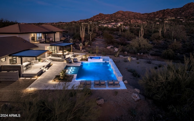 view of swimming pool with an outdoor hangout area, a patio, and a mountain view