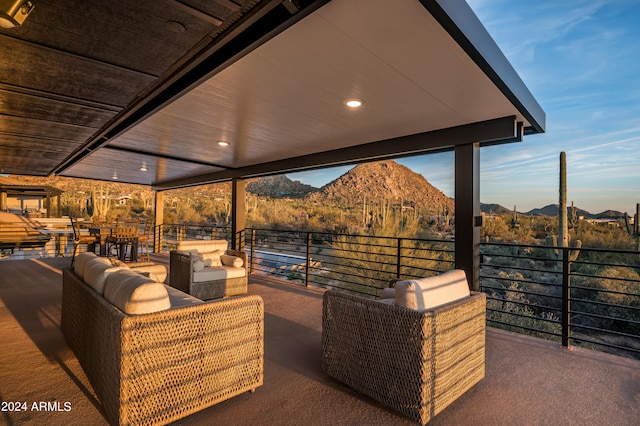 view of terrace featuring a balcony, a mountain view, and an outdoor living space