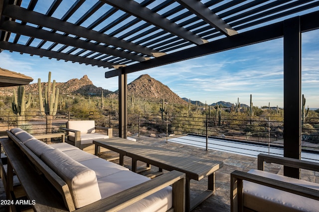 view of terrace with an outdoor hangout area, a pergola, and a mountain view