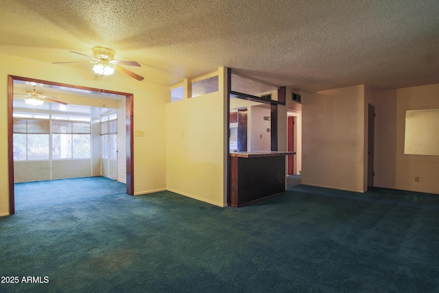 carpeted empty room featuring a textured ceiling and ceiling fan