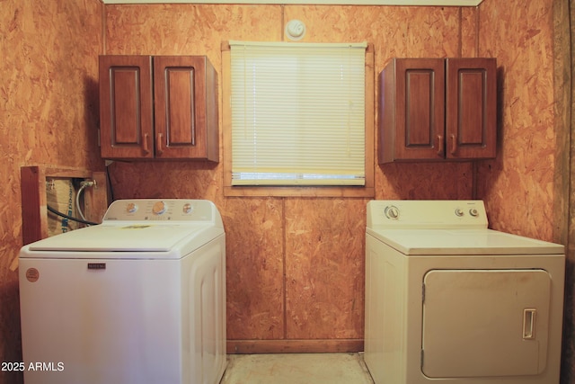 washroom with cabinets and washing machine and dryer