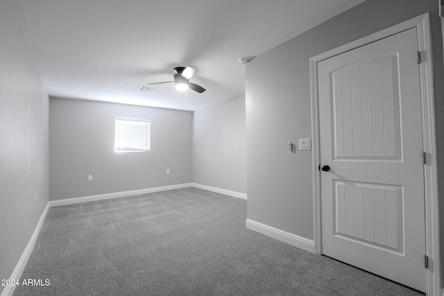 basement with carpet and ceiling fan