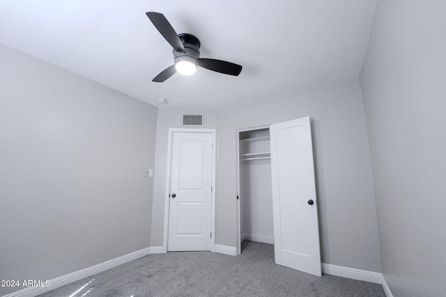 unfurnished bedroom with a closet, ceiling fan, and carpet flooring