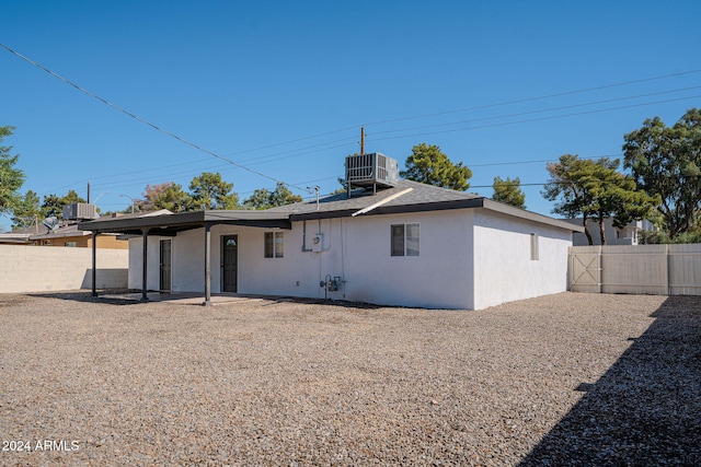 rear view of house featuring a patio and cooling unit