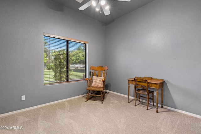 sitting room featuring light colored carpet and ceiling fan