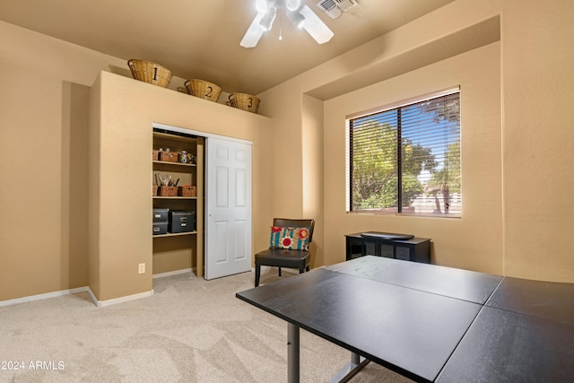 carpeted home office featuring ceiling fan