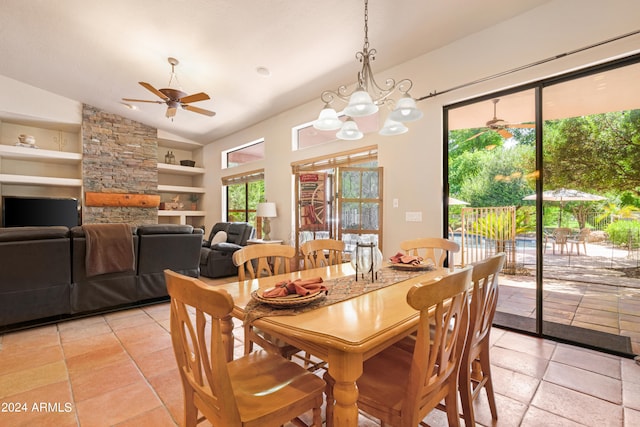 dining space with lofted ceiling, built in features, and ceiling fan with notable chandelier