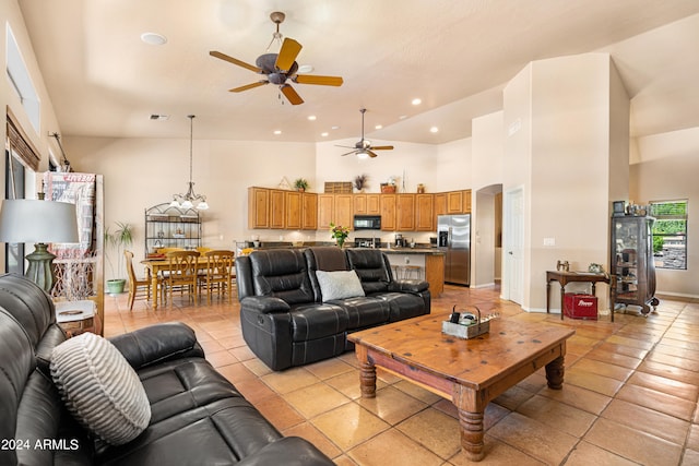 tiled living room with high vaulted ceiling and ceiling fan