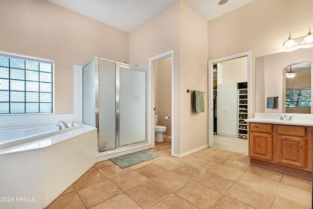 full bathroom featuring plus walk in shower, ceiling fan, toilet, and vanity