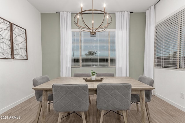 dining room with a chandelier and light wood-type flooring