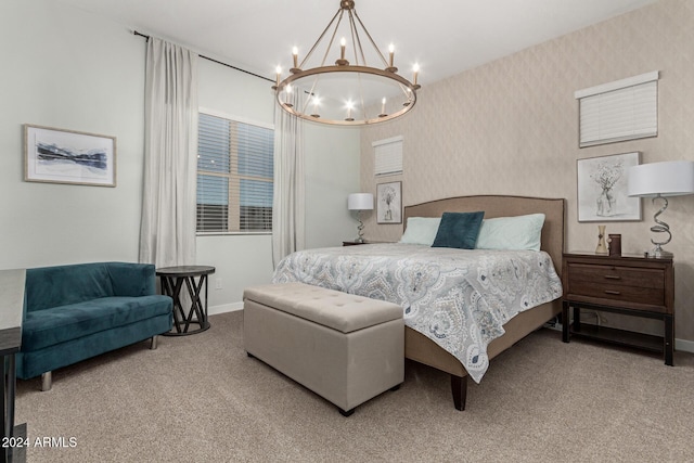 carpeted bedroom featuring an inviting chandelier