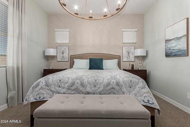 bedroom with carpet floors and an inviting chandelier