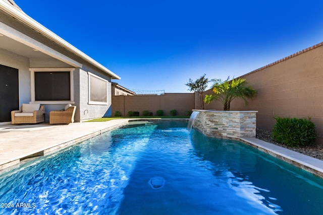 view of pool featuring pool water feature and a patio