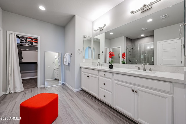 bathroom with vanity and a tile shower