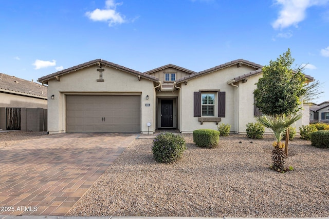 1063 E Holland Park Dr, Gilbert, AZ 85297 - view of front facade with decorative driveway, an attached garage, stucco siding, and a tiled roof