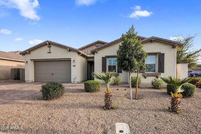 1063 E Holland Park Dr, Gilbert, AZ 85297 - view of front of house featuring stucco siding, driveway, an attached garage, and a tile roof