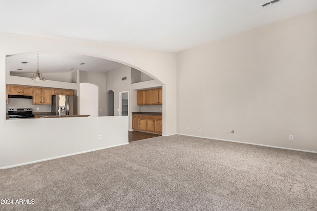 unfurnished living room with lofted ceiling, an inviting chandelier, and carpet floors