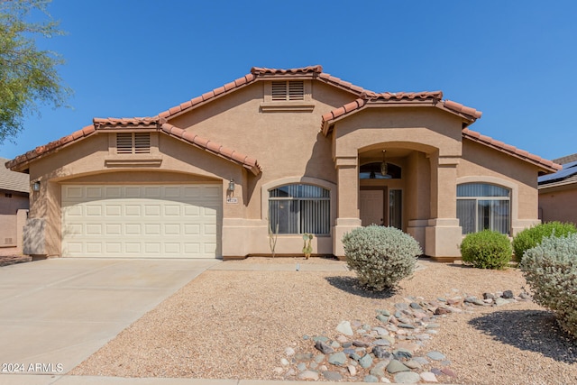 mediterranean / spanish-style home featuring a garage