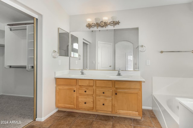 bathroom featuring tile patterned floors, a tub to relax in, and vanity