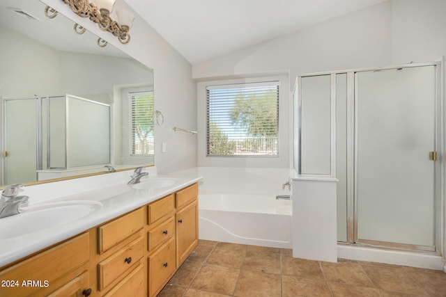 bathroom featuring tile patterned floors, vaulted ceiling, independent shower and bath, and vanity