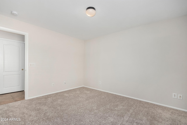 unfurnished room featuring light colored carpet