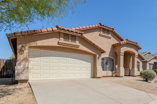 mediterranean / spanish-style house featuring a garage