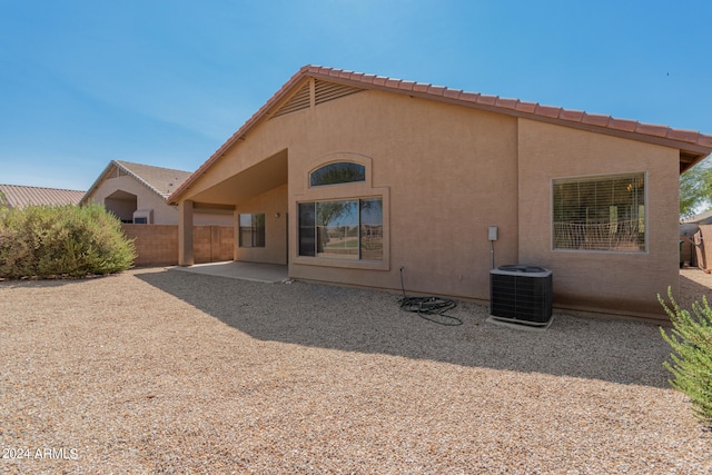 back of house with central AC unit and a patio