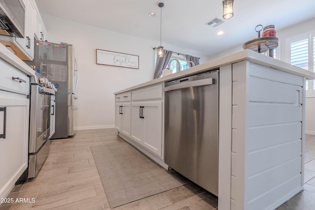 kitchen with light wood finished floors, dishwasher, and white cabinets