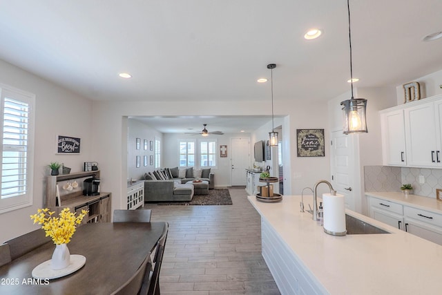 kitchen with white cabinets, recessed lighting, dark wood-style floors, and a sink