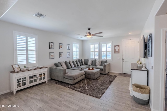 living area with baseboards, light wood-type flooring, recessed lighting, a ceiling fan, and visible vents