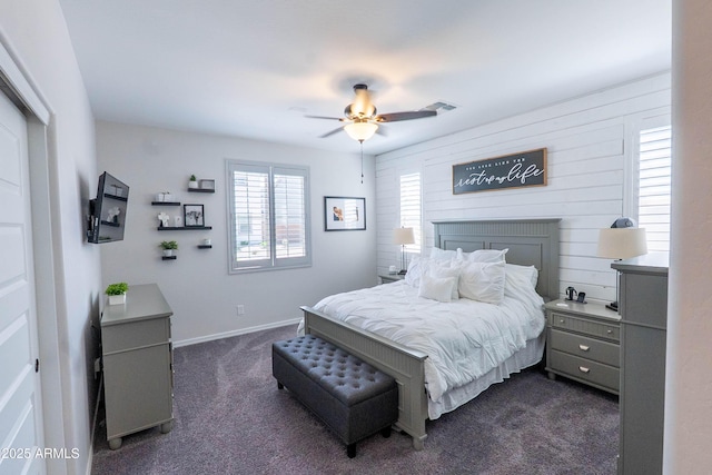 bedroom featuring dark carpet, ceiling fan, visible vents, and baseboards