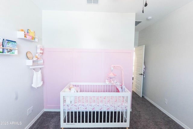 bedroom featuring a crib, carpet, and visible vents