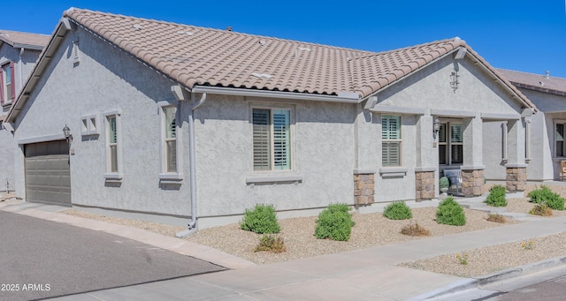 exterior space featuring a garage, stucco siding, and a tiled roof