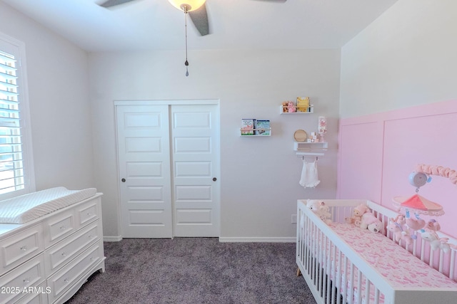 bedroom with a closet, multiple windows, dark carpet, and ceiling fan