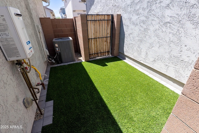 view of yard featuring central air condition unit and fence