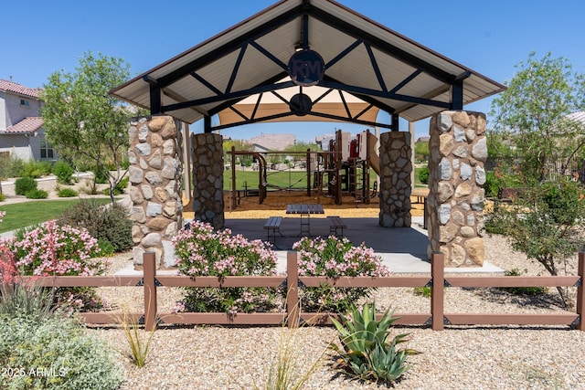 view of patio featuring fence and a playground
