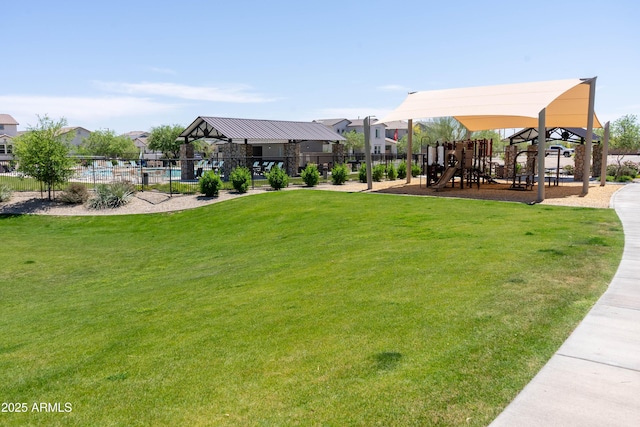 surrounding community featuring a yard, fence, a residential view, and playground community