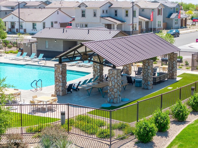 community pool featuring a residential view, a gazebo, a patio area, and fence