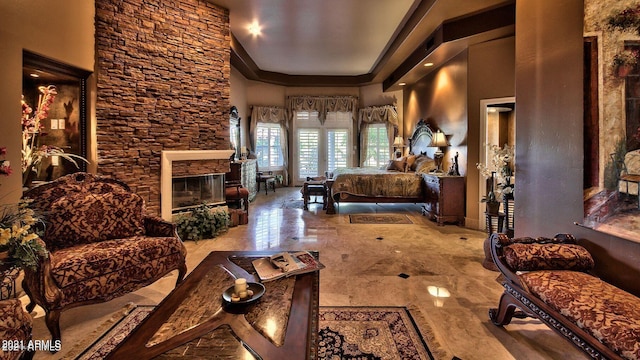 bedroom featuring a stone fireplace