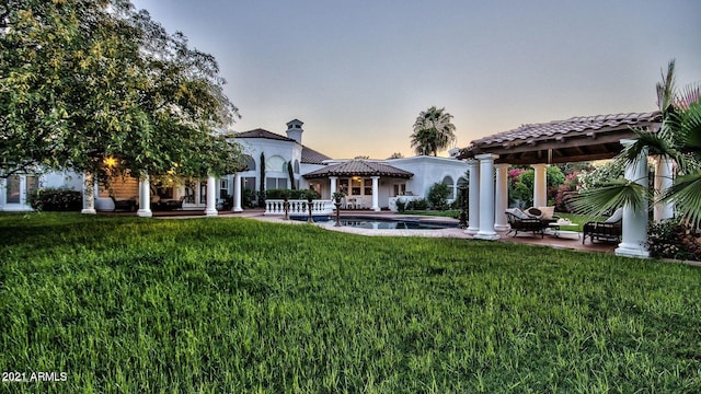 yard at dusk with a gazebo and a patio